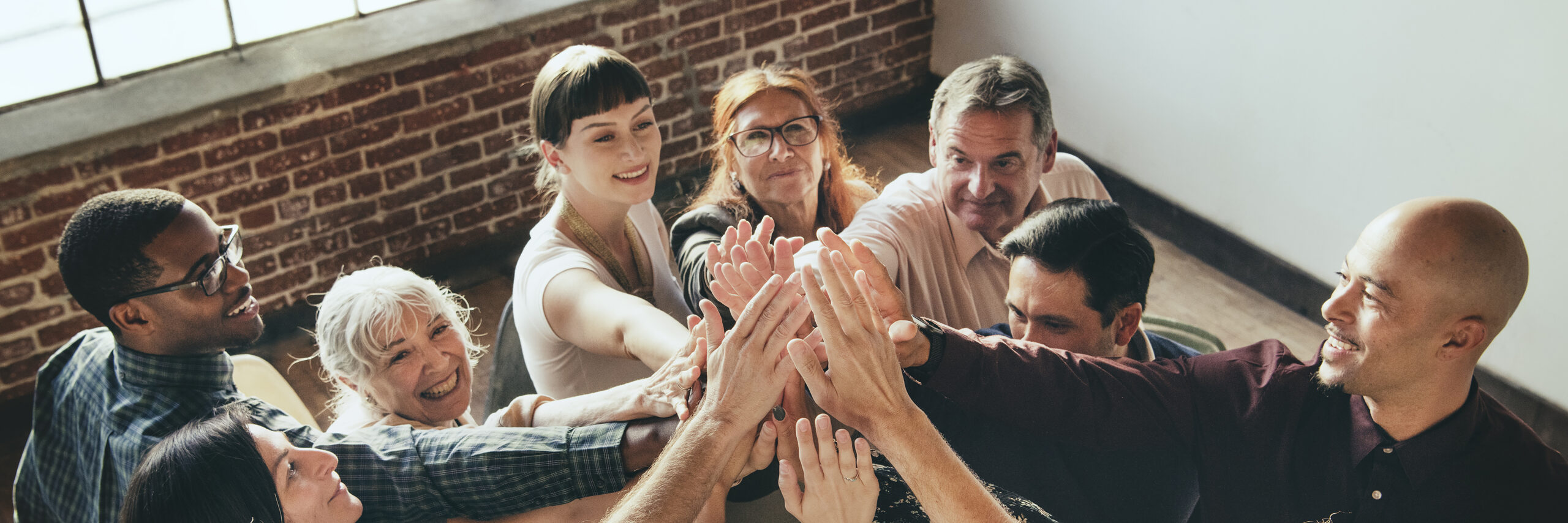 People joining hands in the air at a meeting